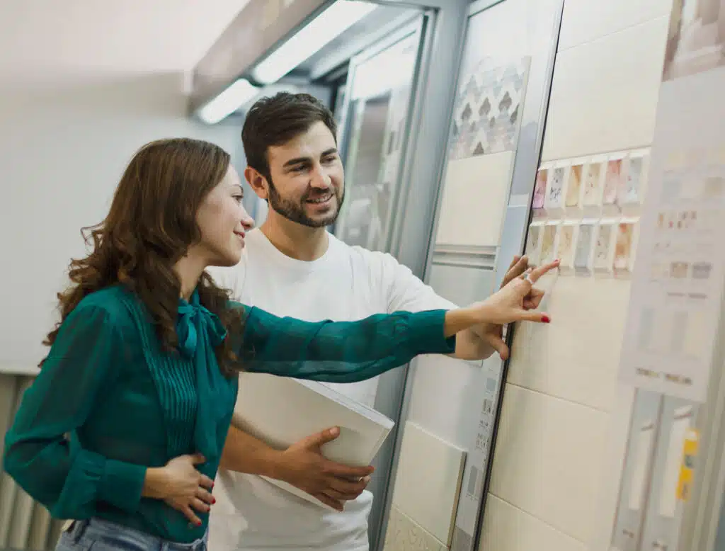 a man and woman looking at a tile display
